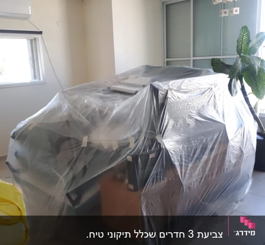 רהיטים מכוסים בניילון לקראת צביעה